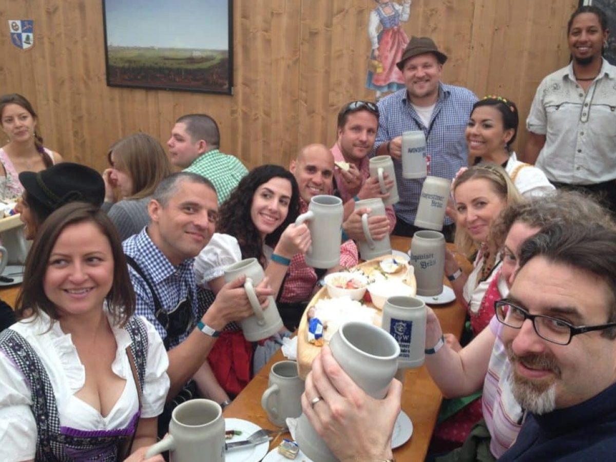 a group of people sitting at a table posing for the camera