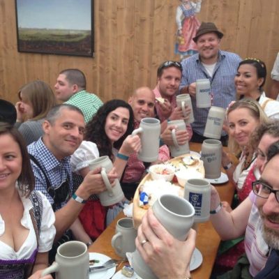 a group of people sitting at a table posing for the camera