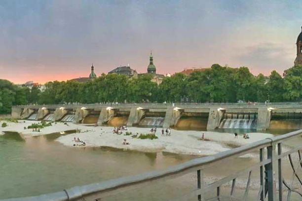 a small boat in a body of water with buildings in the background