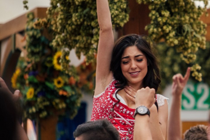 a man holding a frisbee in front of a crowd