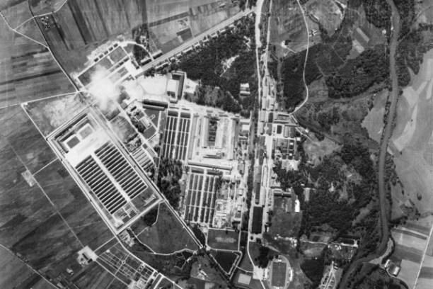 Aerial view of industrial complex surrounded by fields and a river.