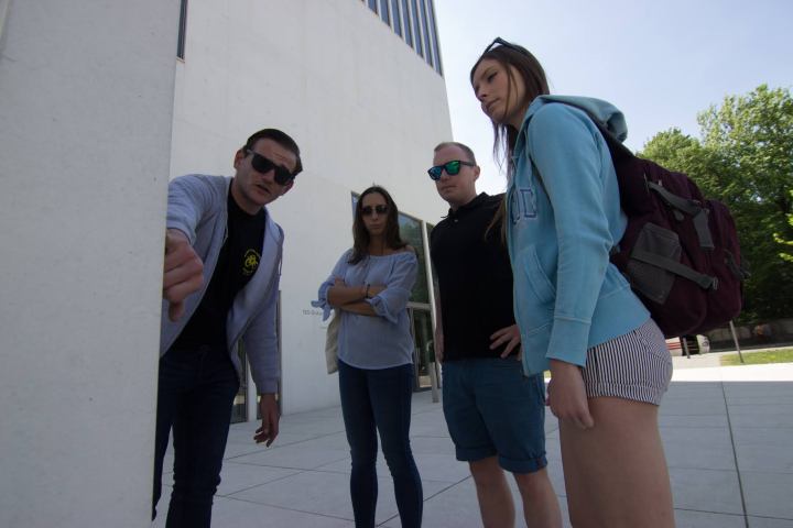 Tour guide showing guests a memorial