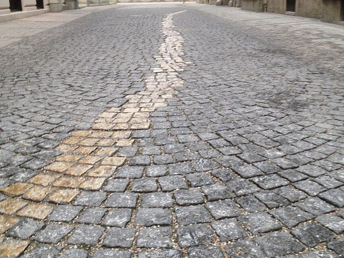 Memorial in munich. Curved cobblestone street with a wavy pattern.