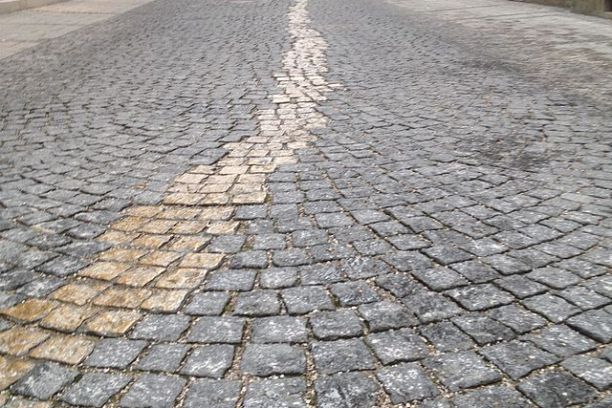 Memorial in munich. Curved cobblestone street with a wavy pattern.