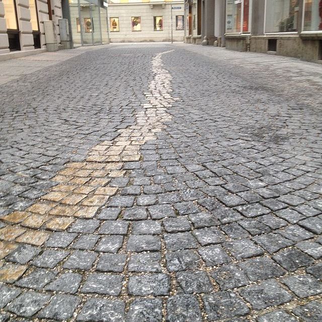 Memorial in munich. Curved cobblestone street with a wavy pattern.