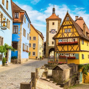 Colorful historic buildings on a cobblestone street under a blue sky