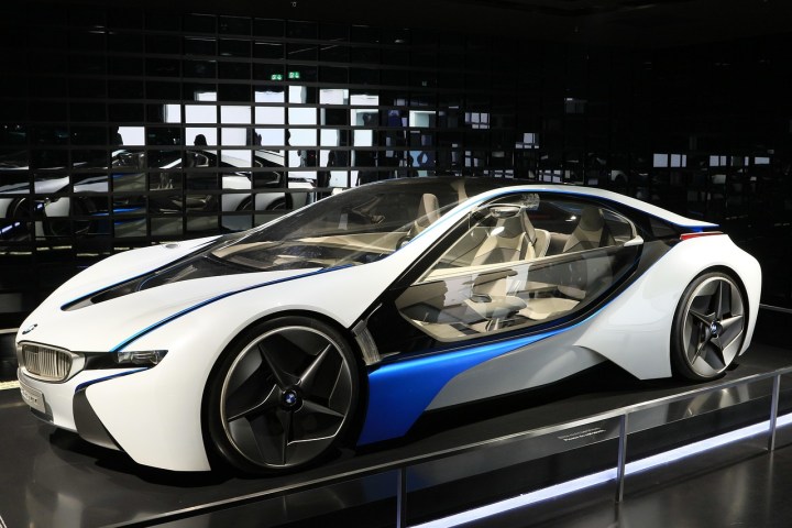 Futuristic white and blue concept car with sleek design on display.