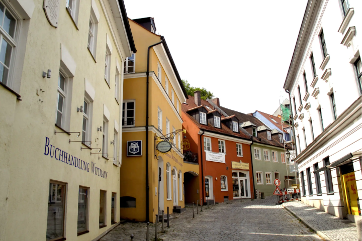 A cobblestone street lined with colorful buildings in the Dachau old town
