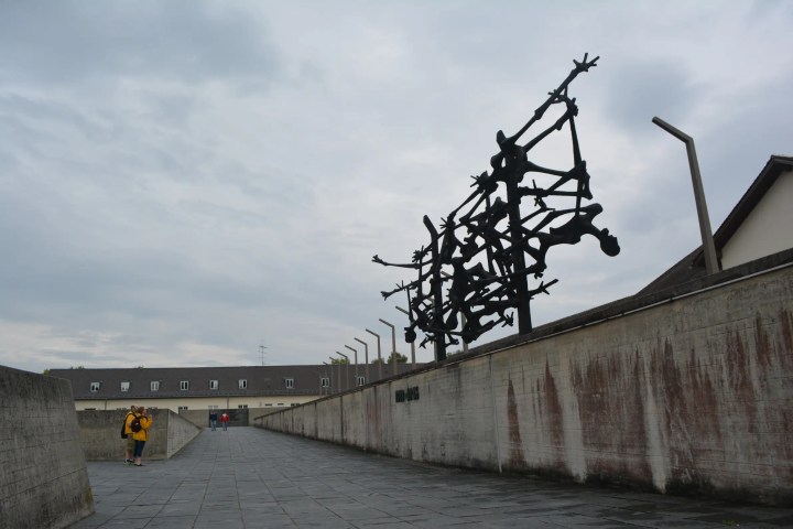 Sculpture resembling twisted figures on a wall at the dachau memorial site