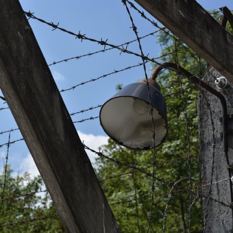 Outdoor light with barbed wire and wooden frame