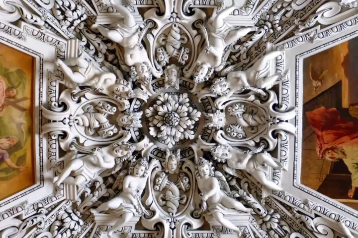 Ornate Baroque ceiling inside a historic church in Salzburg