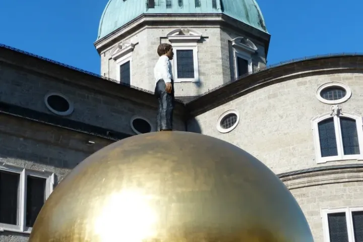Sphaera sculpture in Kapitelplatz with Salzburg Cathedral behind it